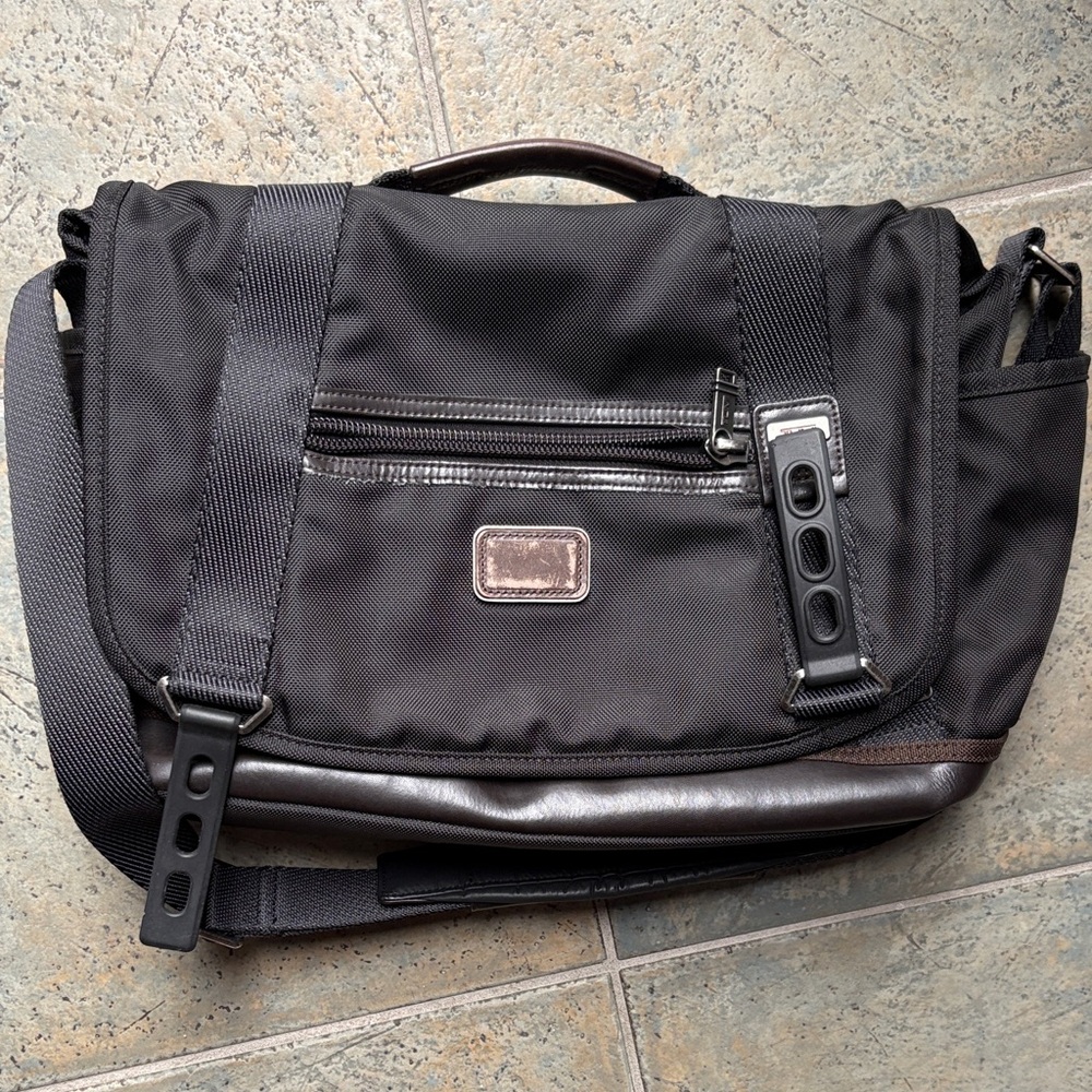 Tumi Black Messenger Bag with Dark Brown Trim and Leather Base